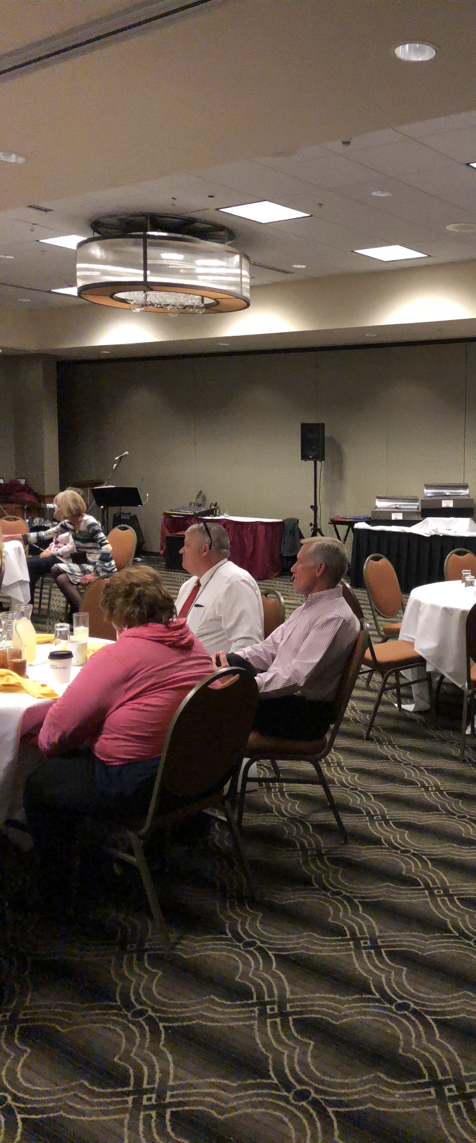People gathered in a conference room attending a presentation or meeting.