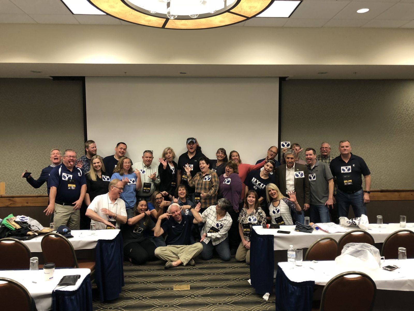 Group photo of people at a conference in a meeting room.