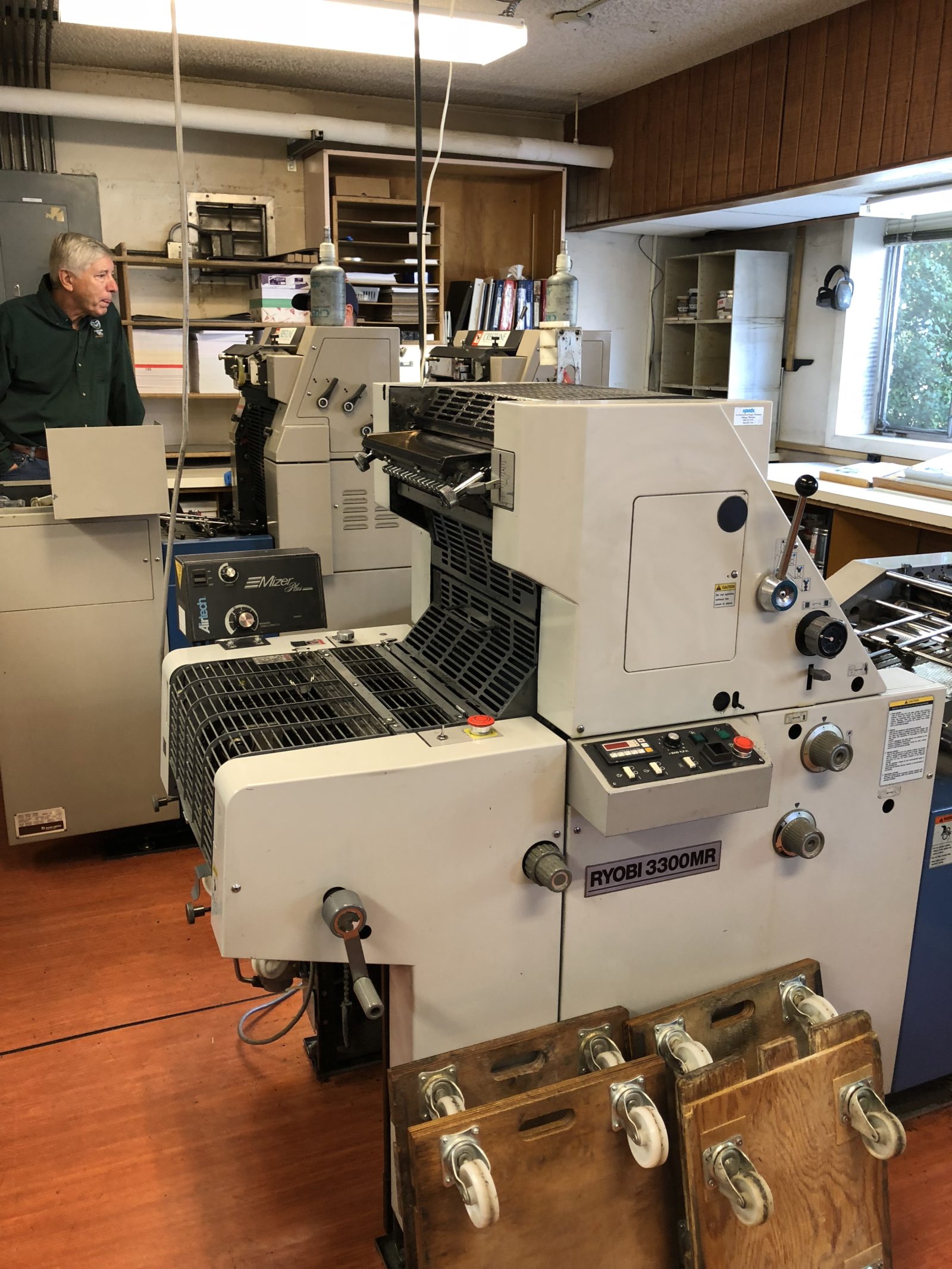 Old-fashioned printing press in a rustic workshop.