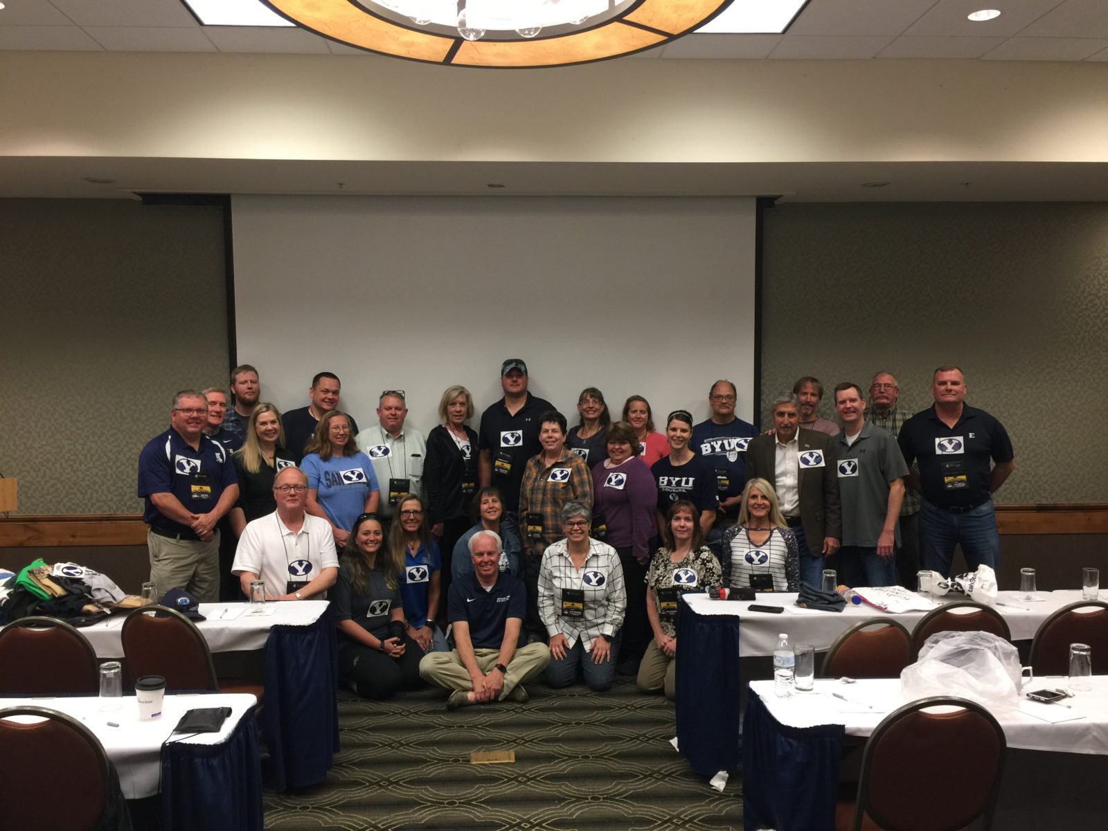 Group photo of people in a conference room setting.
