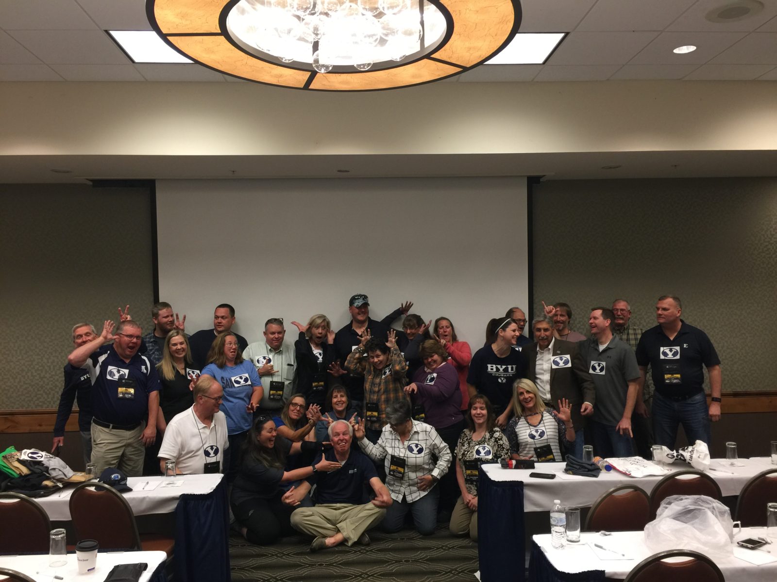Group of people posing together in a conference room.