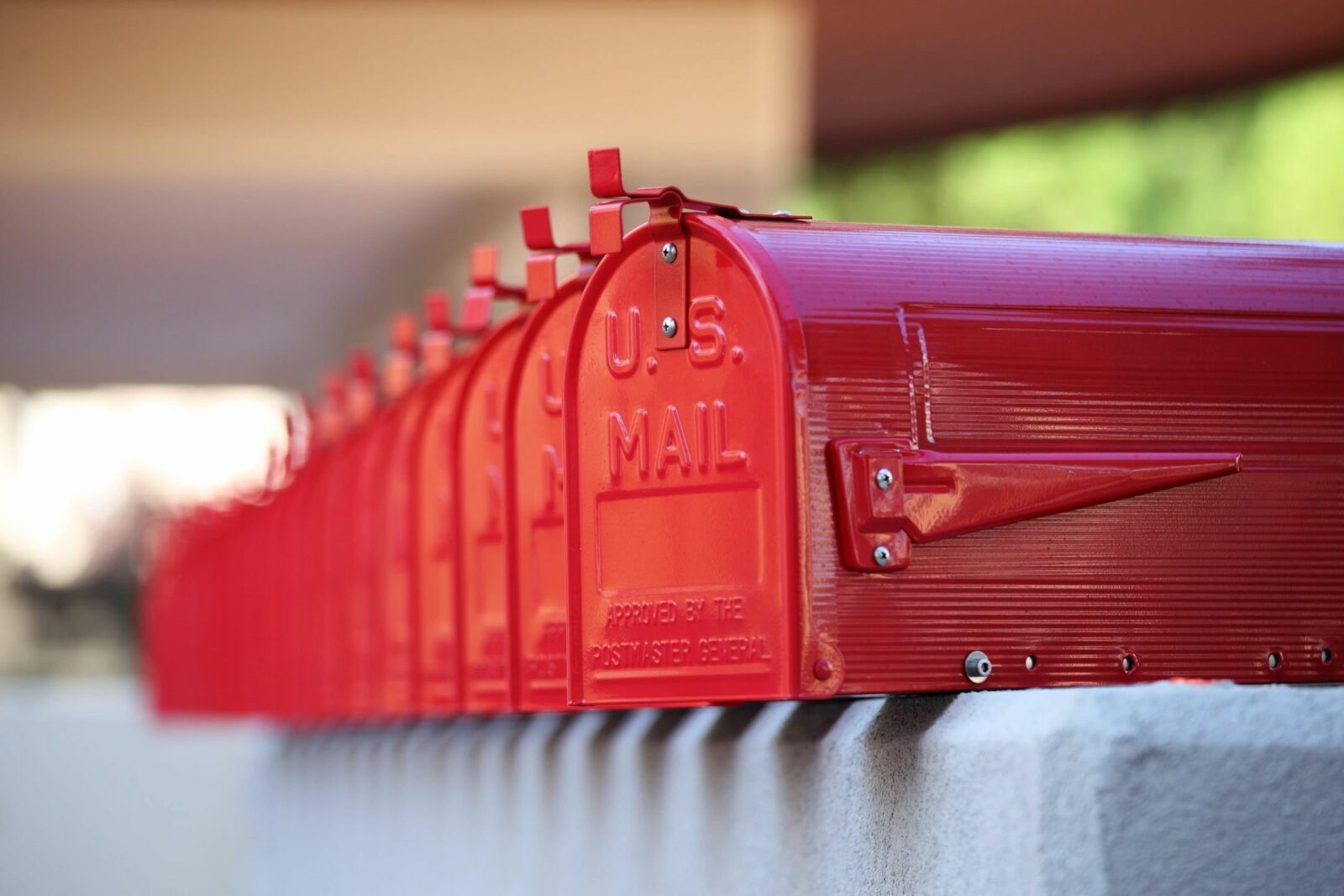 A row of red mailboxes lined up outdoors.